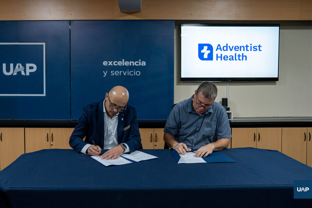Dr. Daniel Heissenberg firma el convenio con autoridad del Adventist Health. 
